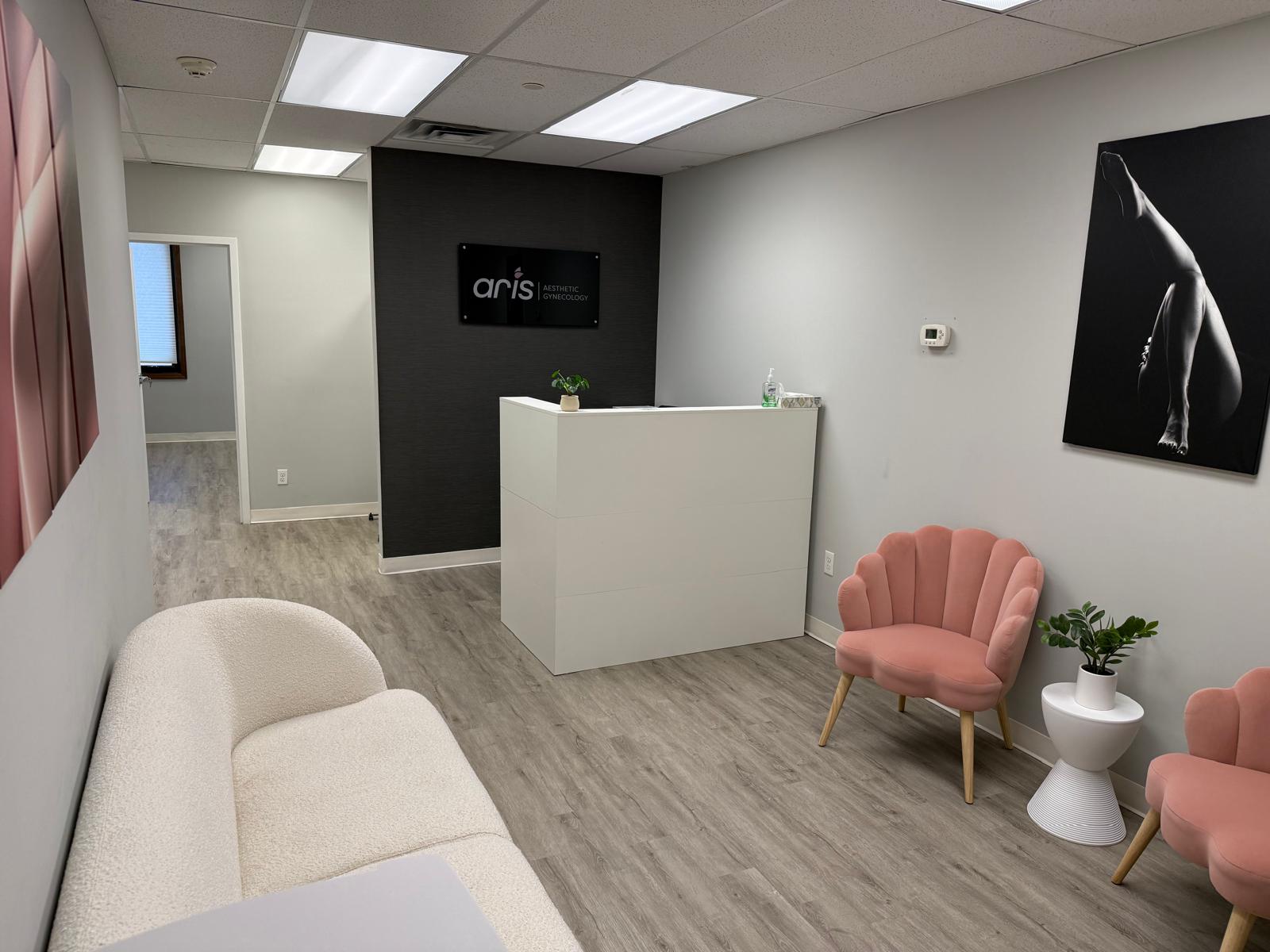 Aris Aesthetic Gynecology reception signage in a private clinical setting