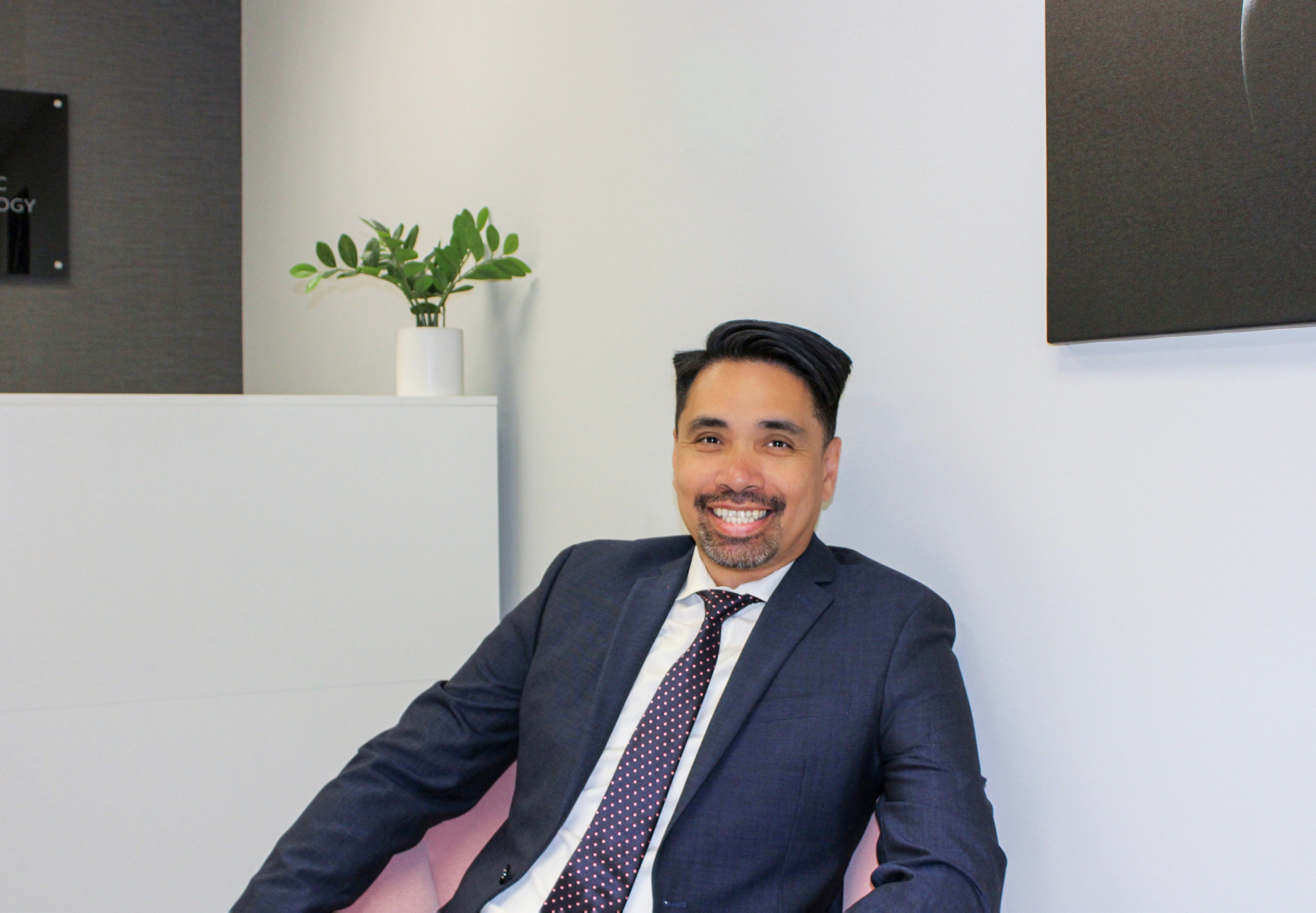 Dr. Antonio seated in the Aris office